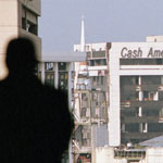 A RadioShack Corporation security guard looks toward buildings that suffered a direct hit from a tornado. The storm killed two people and caused millions of dollars in damage to the downtown Fort Worth area.