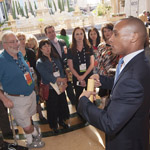IMEX America attendees listen as Shahid Holmes, assistant director of operations for The Venetian Hotel and Casino, explains how their event staff manages large group arrivals during a back of house tour.