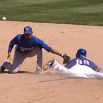 Not realizing he bobbled the catch, Kansas City Royals shortstop Tony Pena tries to tag Texas Rangers center fielder Craig Gentry.