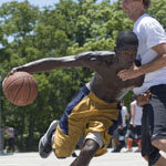 Roderick Johnson drives toward the basked during the Hoop-It-Up Tournament at Fair Park in Dallas, Texas.