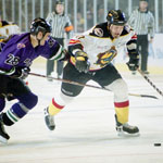 Fort Worth Brahmas defenseman Mike Rusk (#28) tries to beat New Mexico Scorpions right wing Peter Brearley (#11) to the puck.
