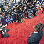 NFL prospect Shaquem Griffin poses for photographers on the red carpet during the NFL Draft in Arlington, Texas. 
