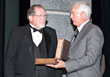 Earl Dohner, AAM, left, ASA’s incoming chairman, accepts the chairman’s gavel from Ron Pyle, president and chief staff executive of ASA.